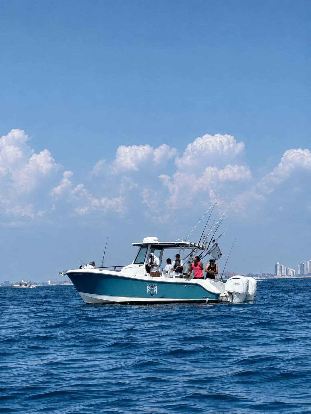 The Fishing The Atlantic boat running offshore under tall cumulus, anglers along the rail.
